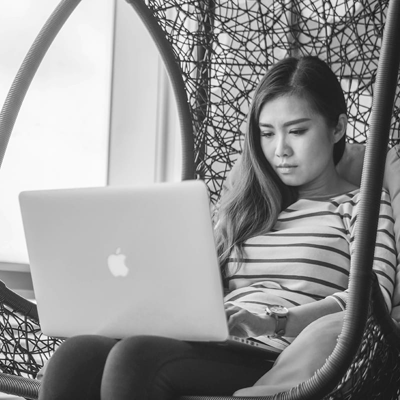 A woman illustrating in a chair